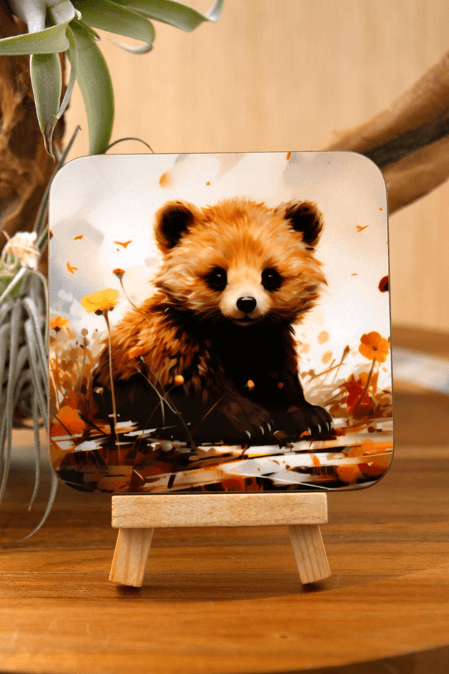 Square Coaster: Adorable Bear Cub Nestled in Lush Foliage Design
